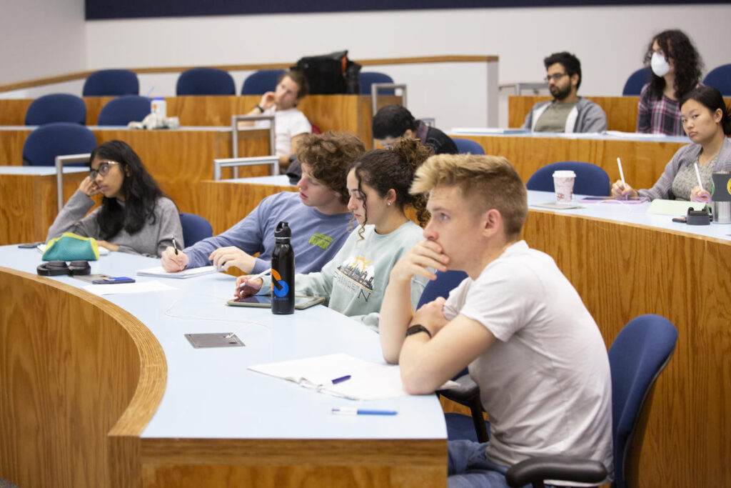 Undergraduates listening to a lecture on quantum mechanics under a new teaching approach: not all of this is on the test.