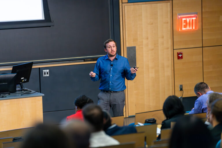 Color image of Todd Hyster standing in front of an audience
