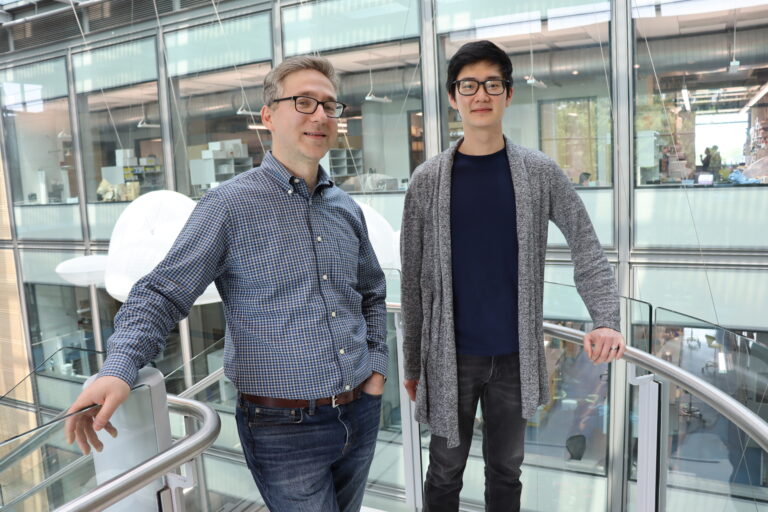 Full-color image of professor and grad student standing in Frick Lab.