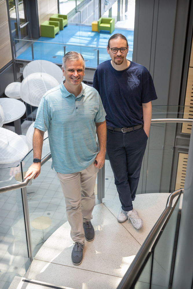 Color image of P.I. Paul Chirk (left) and postdoc Reginald Mills standing in Frick.