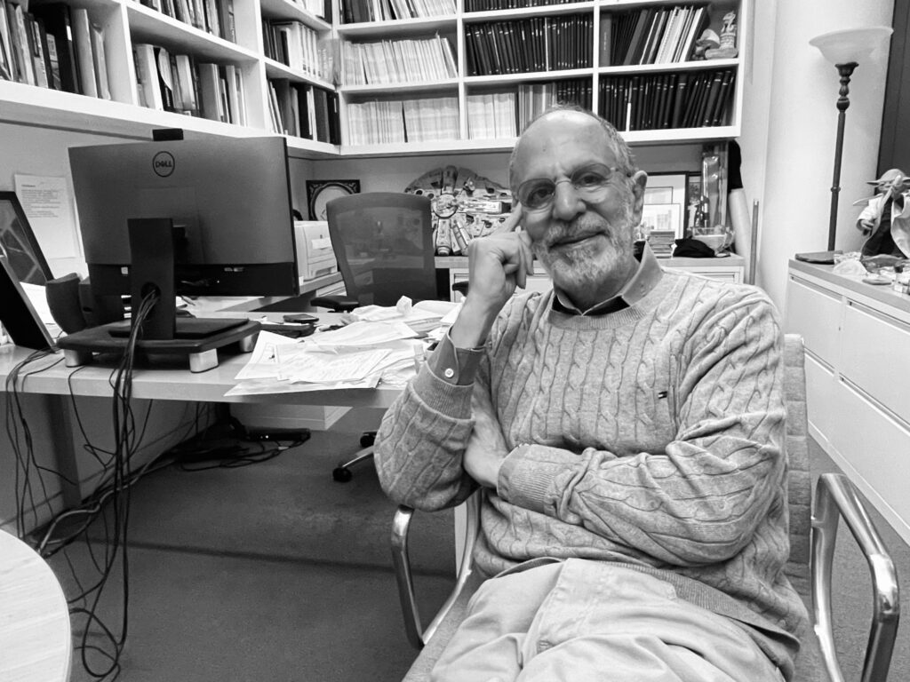 Black-and-white image of P.I. Robert Cava in his office.